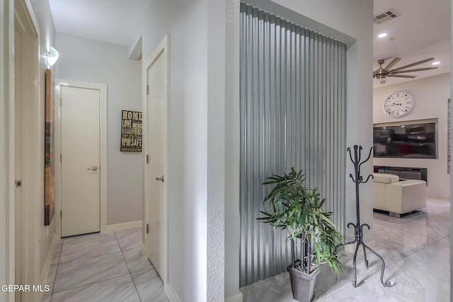 corridor featuring visible vents and baseboards