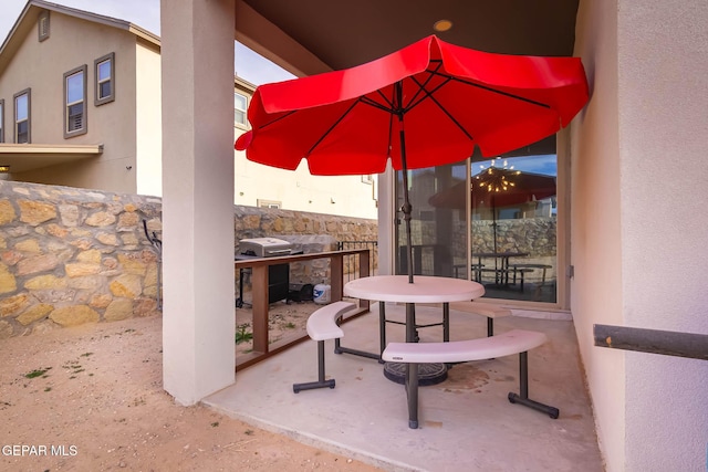 view of patio featuring area for grilling and fence