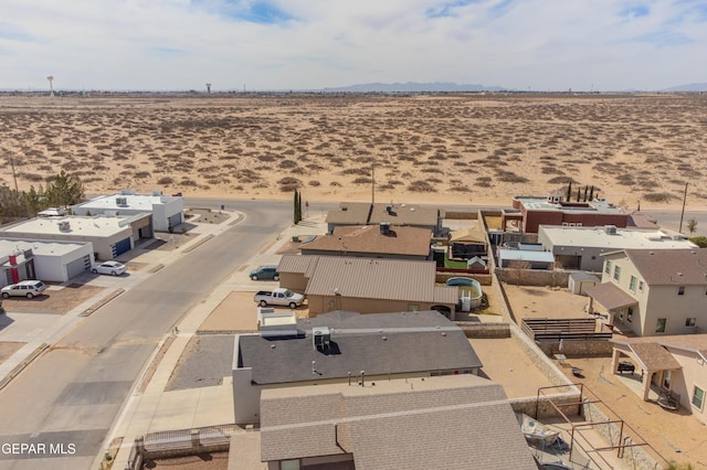 birds eye view of property featuring view of desert and a mountain view