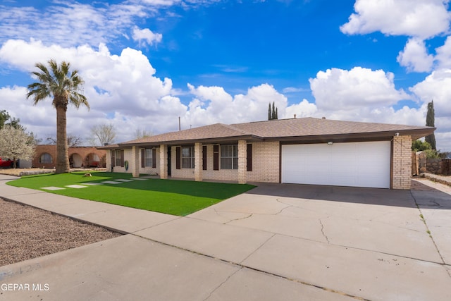 ranch-style home featuring brick siding, a shingled roof, concrete driveway, an attached garage, and a front yard