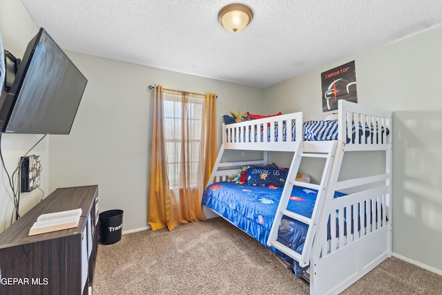 bedroom featuring carpet, a textured ceiling, and baseboards