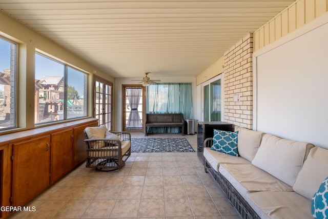 sunroom featuring a ceiling fan