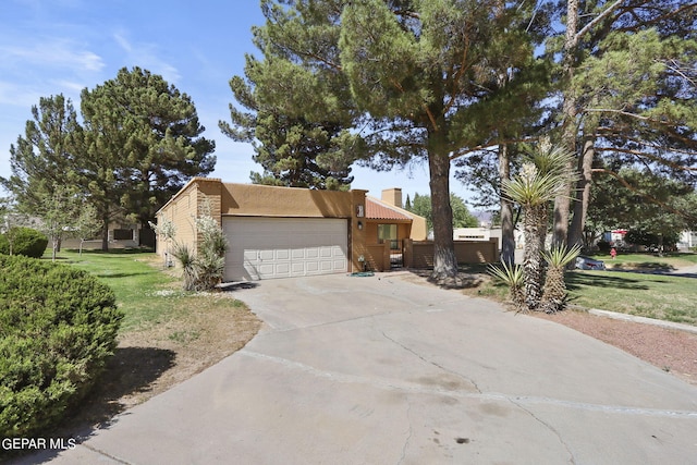 view of front of property with a garage, concrete driveway, stucco siding, a front lawn, and a chimney