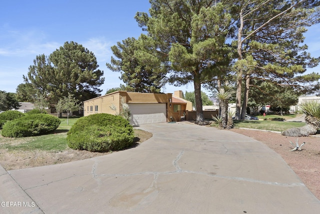 view of front of home featuring a garage, driveway, and stucco siding