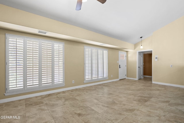 unfurnished room with a ceiling fan, lofted ceiling, visible vents, and baseboards