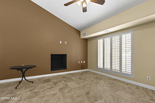 spare room with lofted ceiling, ceiling fan, visible vents, and baseboards