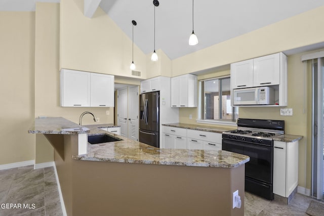 kitchen with white microwave, a peninsula, black range with gas stovetop, refrigerator with ice dispenser, and a sink