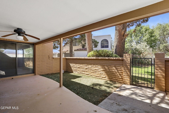 view of patio / terrace with a gate, a ceiling fan, and fence