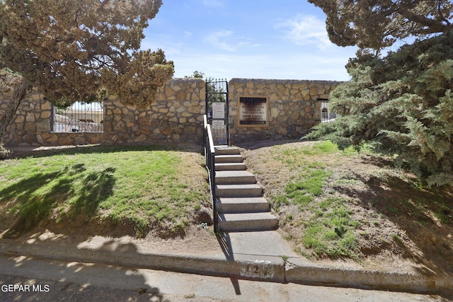 view of yard featuring fence and a gate