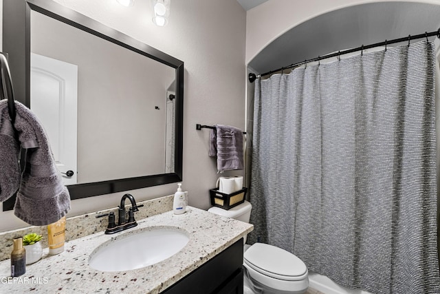 full bathroom featuring toilet, shower / bath combo, and vanity