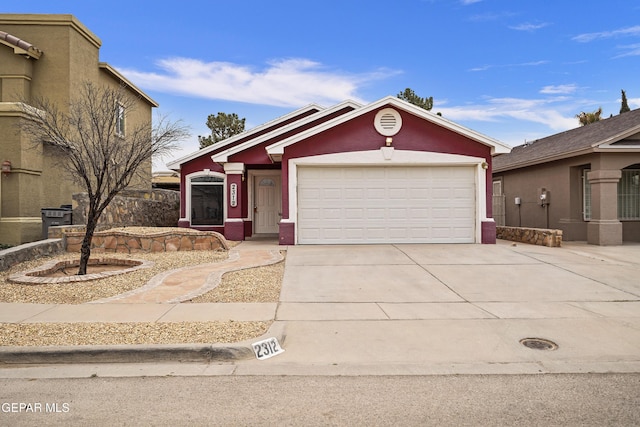 view of front of house featuring driveway, an attached garage, and stucco siding