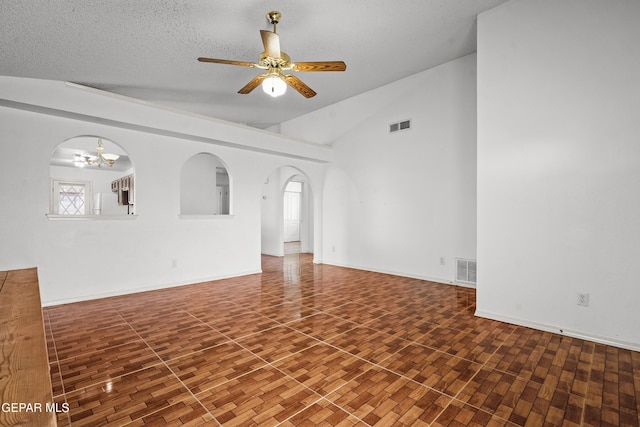 spare room with arched walkways, visible vents, a textured ceiling, and ceiling fan with notable chandelier