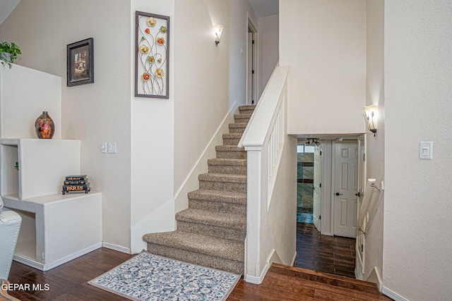 stairs with baseboards and wood finished floors