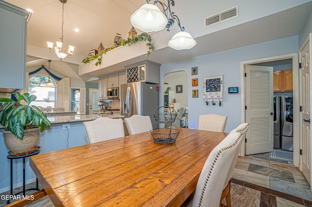 dining space featuring arched walkways, visible vents, and an inviting chandelier