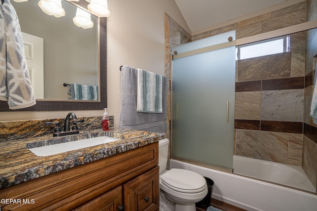 bathroom with lofted ceiling, enclosed tub / shower combo, vanity, and toilet