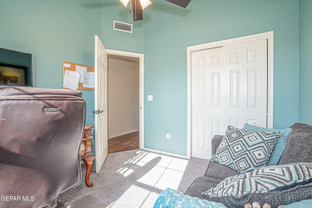 interior space with ceiling fan, carpet, visible vents, and baseboards