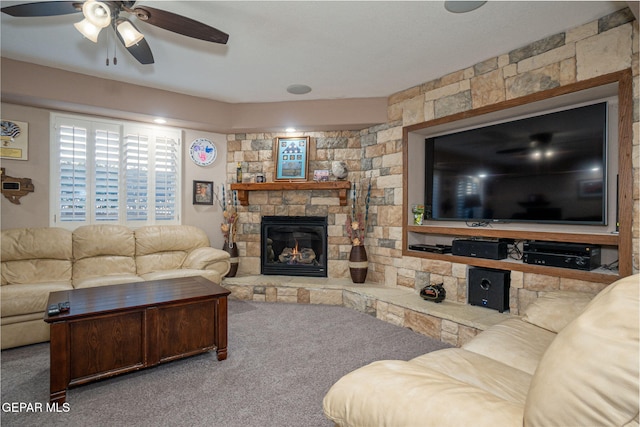 carpeted living room with a fireplace and a ceiling fan