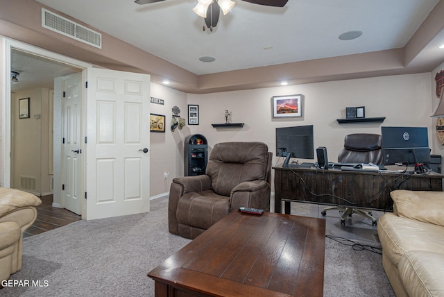 carpeted home office with ceiling fan, visible vents, and baseboards