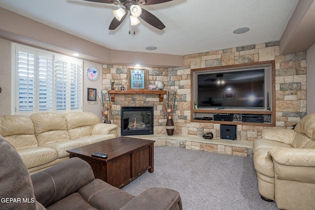 carpeted living area featuring a fireplace and a ceiling fan