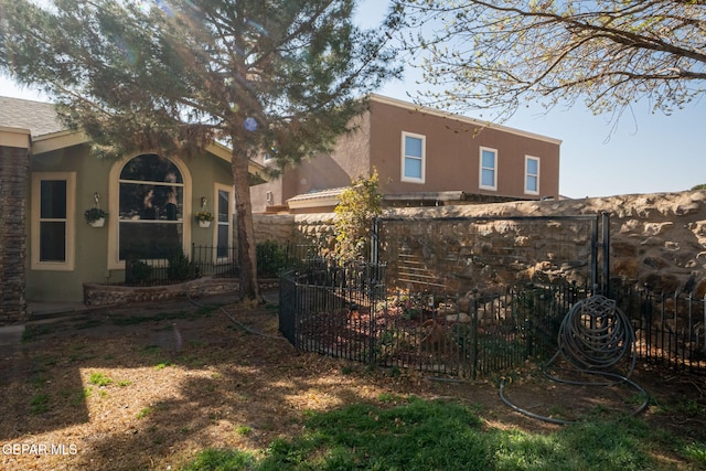 view of property exterior with fence and stucco siding