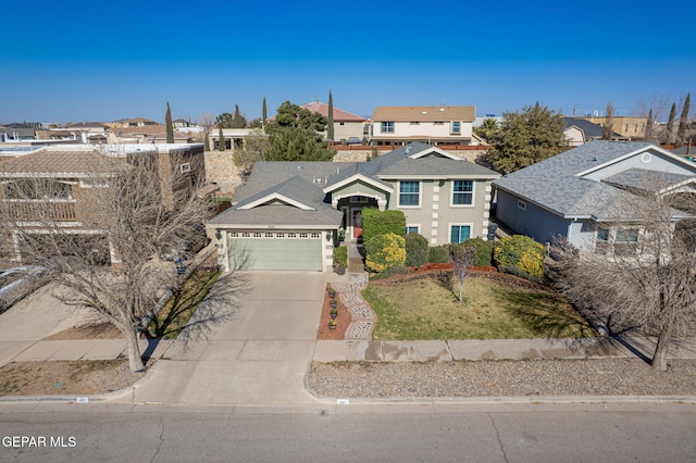 traditional home with a garage, a residential view, driveway, and a front yard