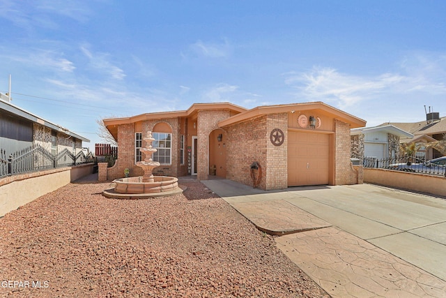 view of front of house featuring a garage, concrete driveway, brick siding, and fence