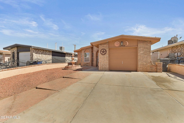 ranch-style home with a garage, brick siding, fence, and driveway