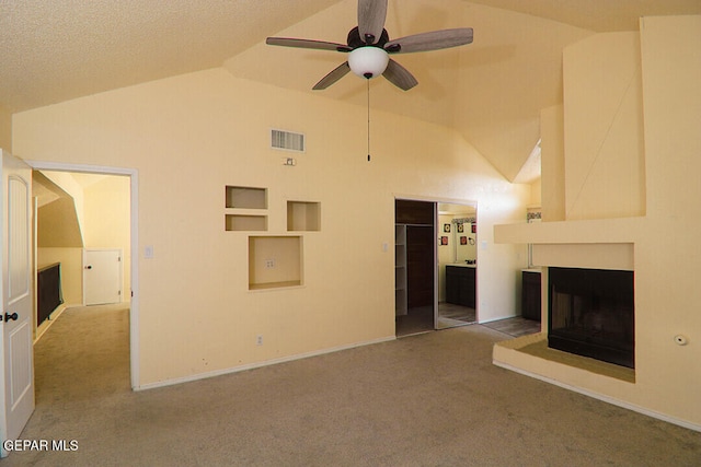 unfurnished living room with carpet floors, a multi sided fireplace, visible vents, and a ceiling fan