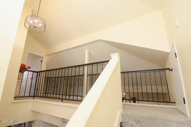 stairway with high vaulted ceiling and carpet flooring