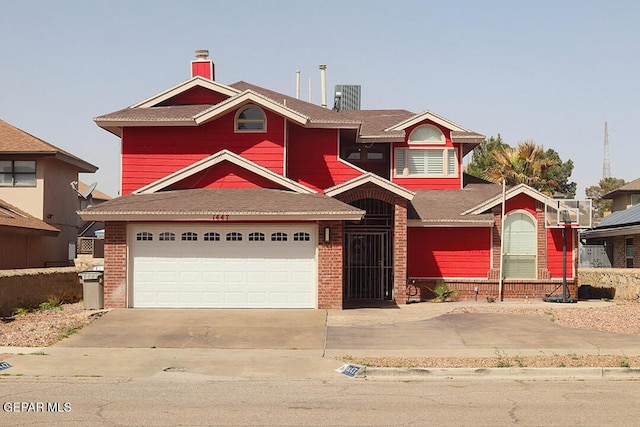 view of front of home with a garage, brick siding, and driveway