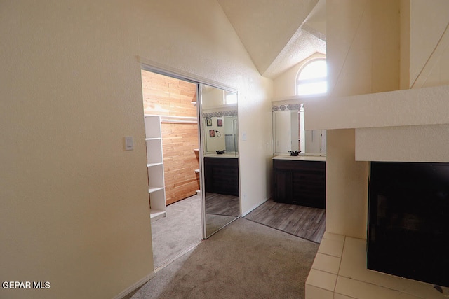 bathroom with high vaulted ceiling and vanity