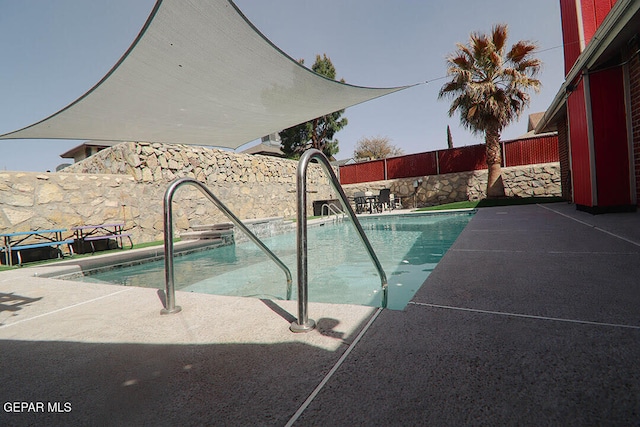 view of swimming pool with a patio area, a fenced backyard, and a fenced in pool