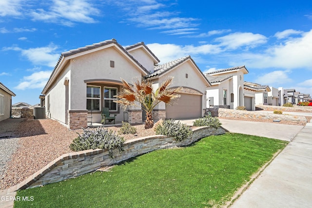 mediterranean / spanish-style house with central AC unit, driveway, an attached garage, stucco siding, and stone siding