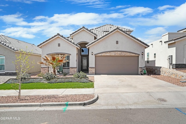 mediterranean / spanish-style house featuring stucco siding, an attached garage, driveway, and a tiled roof