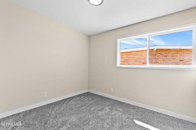 empty room with carpet and baseboards