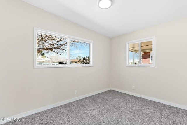 carpeted empty room with baseboards