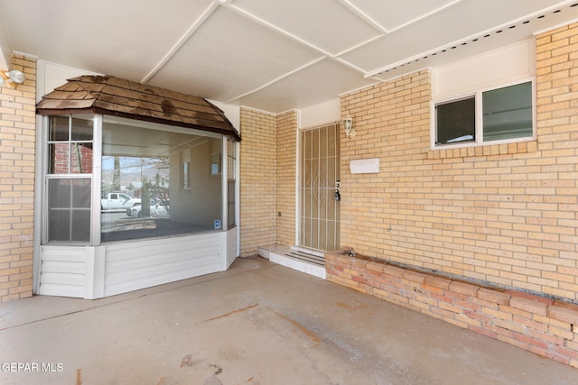 property entrance with brick siding