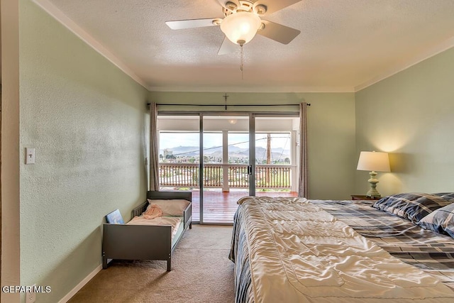 carpeted bedroom featuring ceiling fan, ornamental molding, a textured ceiling, access to outside, and a textured wall