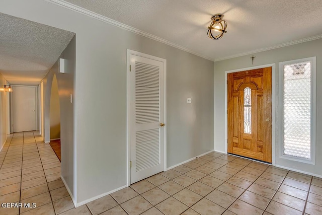 foyer featuring light tile patterned flooring and a textured ceiling