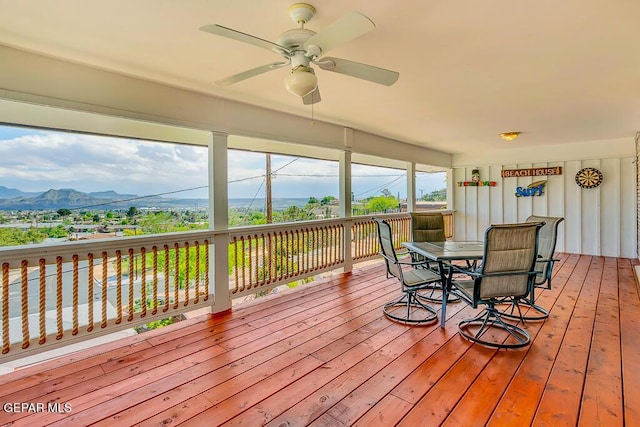 wooden deck with a mountain view and ceiling fan