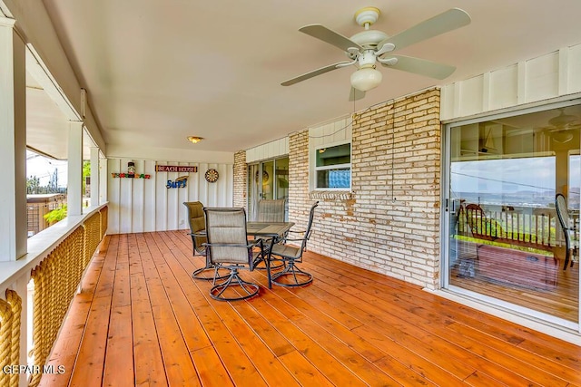 wooden terrace with a ceiling fan