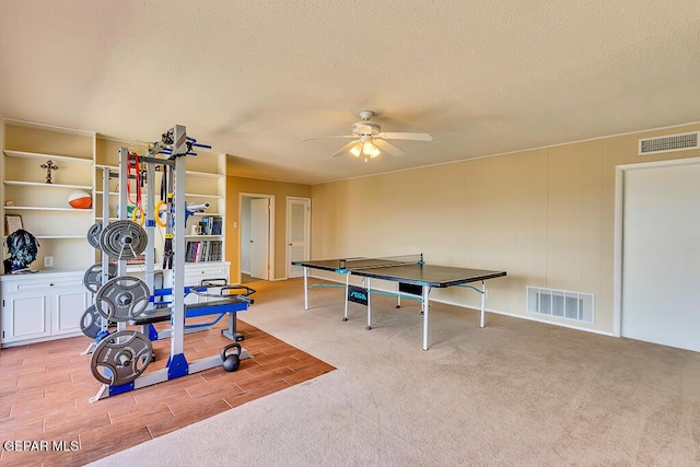 playroom with ceiling fan, visible vents, and a textured ceiling