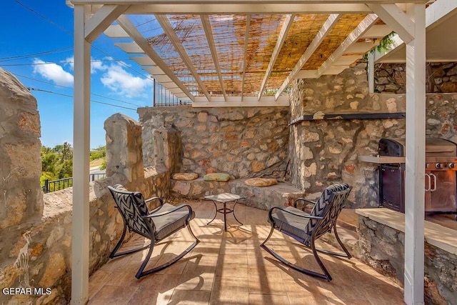 view of patio with grilling area and a pergola