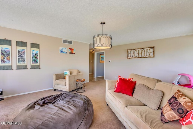 living area with light carpet, visible vents, a textured ceiling, and baseboards