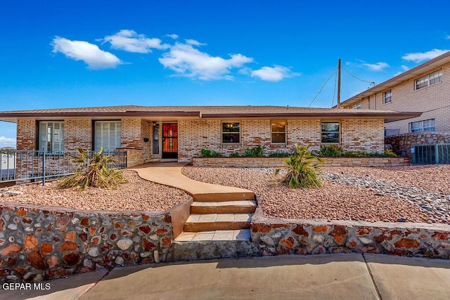 ranch-style house with brick siding and central air condition unit