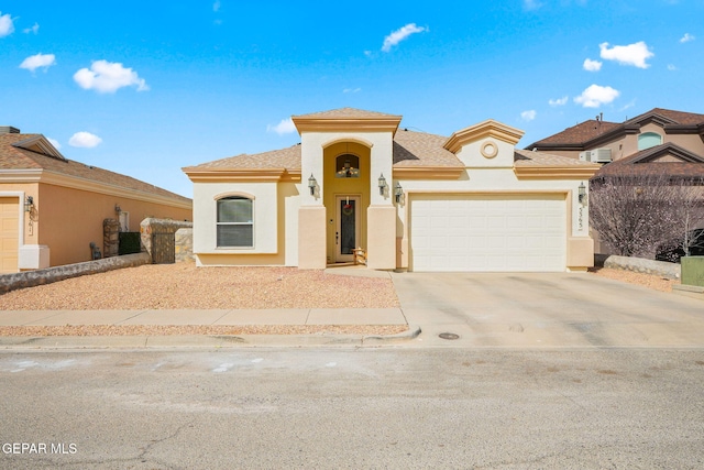 mediterranean / spanish-style home with a garage, concrete driveway, and stucco siding