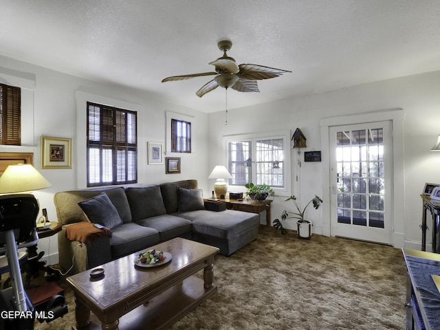 carpeted living area with a ceiling fan