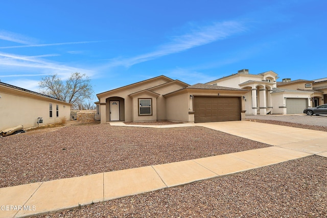 view of front of home featuring concrete driveway, an attached garage, and stucco siding