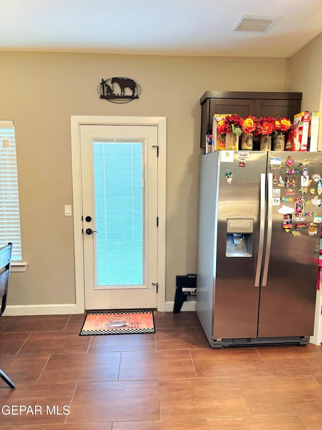 entryway featuring wood finish floors, visible vents, and baseboards