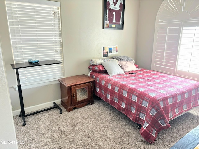 bedroom featuring carpet and baseboards